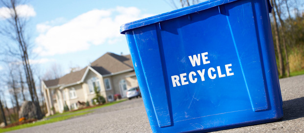 Recycling bin outside of home on curb.